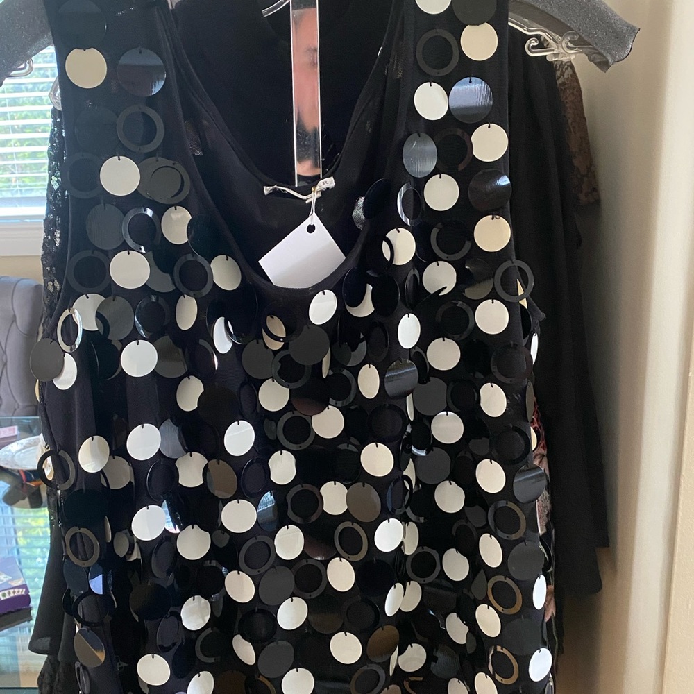 Black and white camisole with discs.